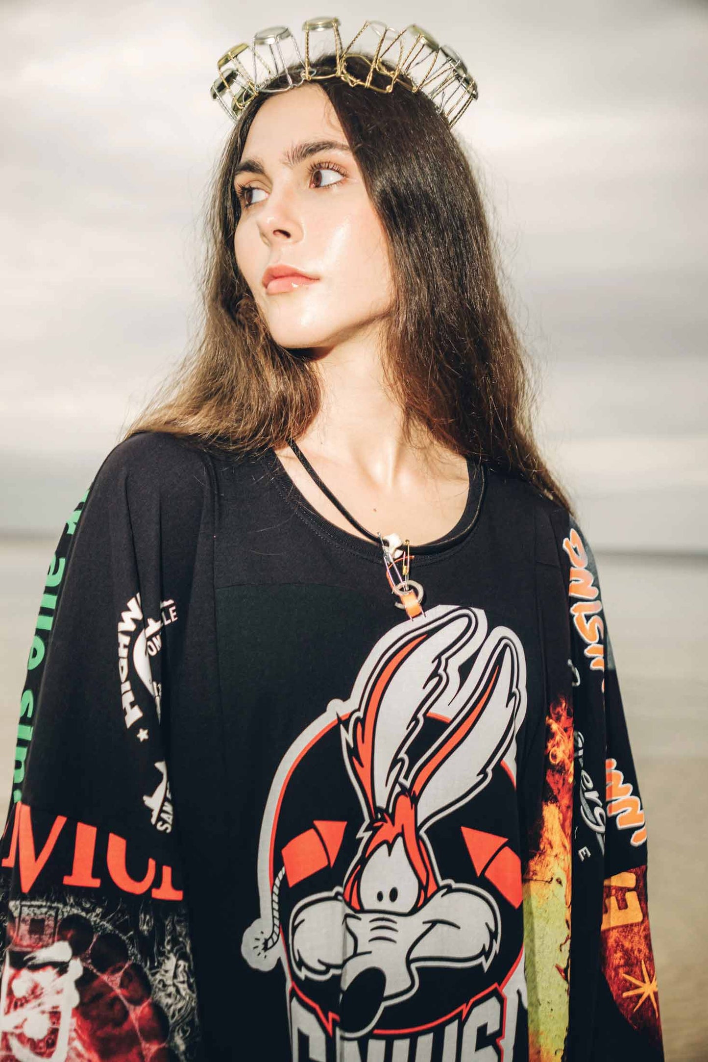 Close-up of upcycled black vintage cotton T-shirt maxi dress, crew neckline and patchwork details.