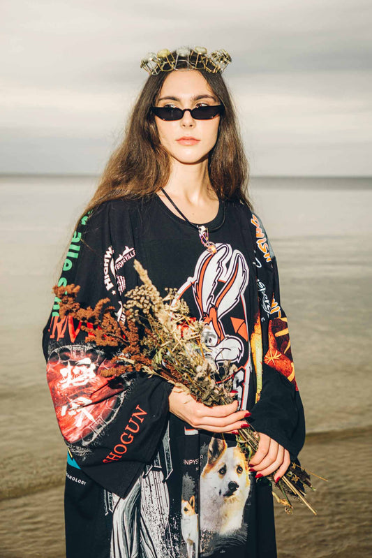 Detail view of oversized maxi dress showing long wide sleeve design and raw vintage cotton texture.