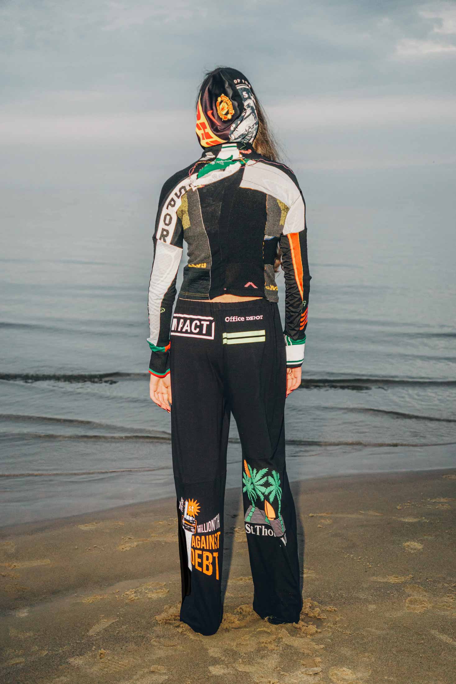 Upcycled black cotton trousers made from thrifted vintage t-shirts, worn on a model.