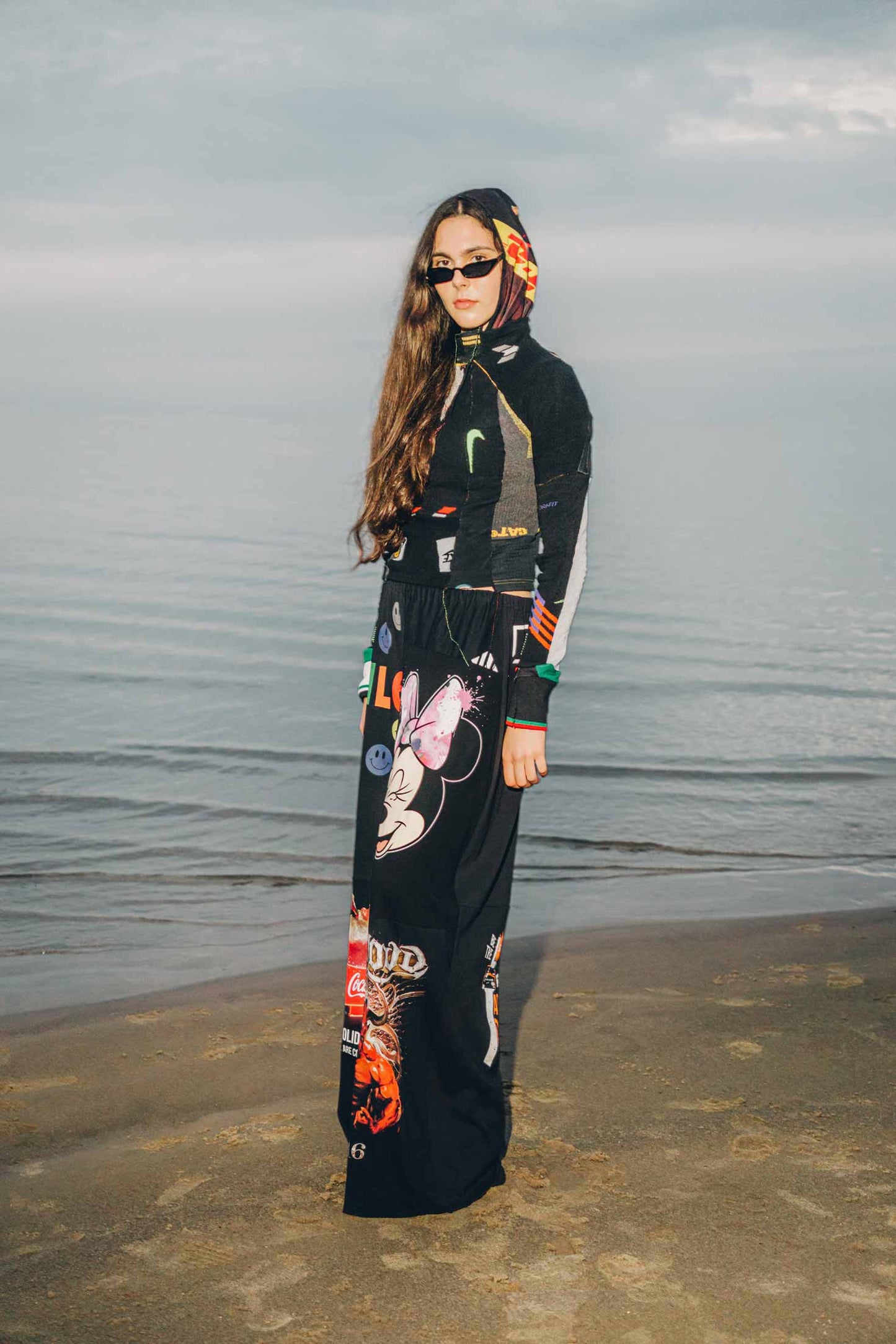 Side view of black wide-leg trousers crafted from reclaimed cotton t-shirts, styled on a model.