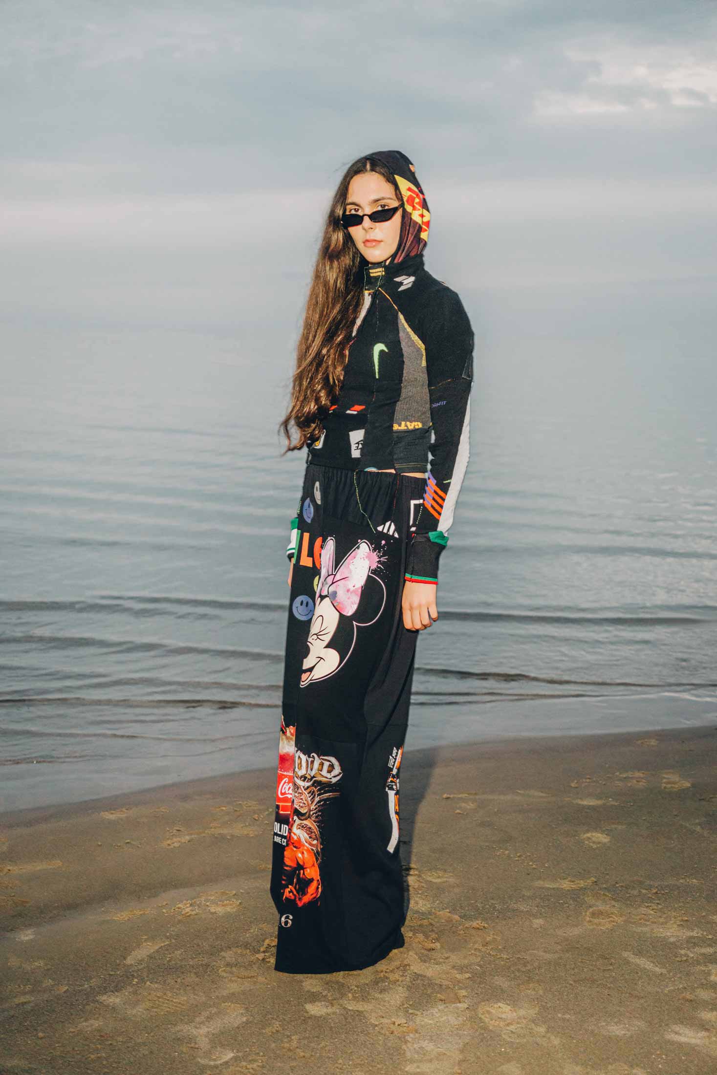 Side view of black wide-leg trousers crafted from reclaimed cotton t-shirts, styled on a model.