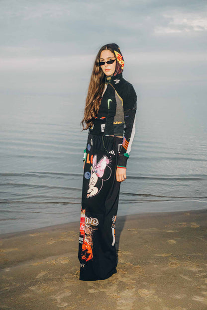 Side view of black wide-leg trousers crafted from reclaimed cotton t-shirts, styled on a model.