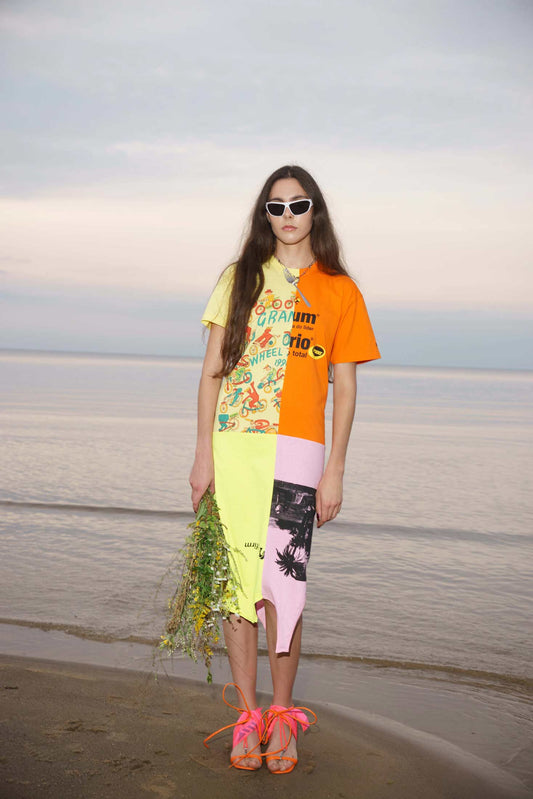 Asymmetrical upcycled t-shirt dress made from multicolor vintage cotton, shown on a model, front view.