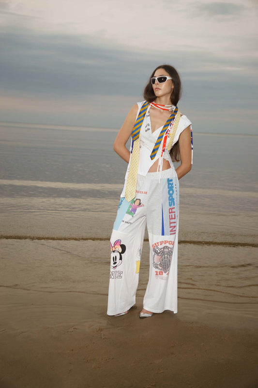 White upcycled wide-leg sweatpants made from reclaimed cotton t-shirts, presented on a model, front view.