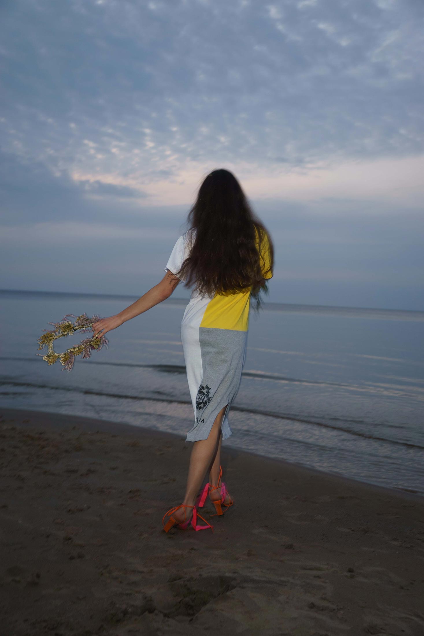Back view of upcycled vintage t-shirt dress in motion, loose fit with raw hem finish.