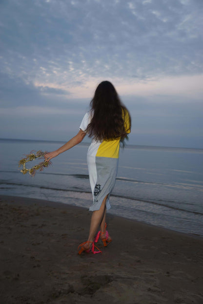 Back view of upcycled vintage t-shirt dress in motion, loose fit with raw hem finish.