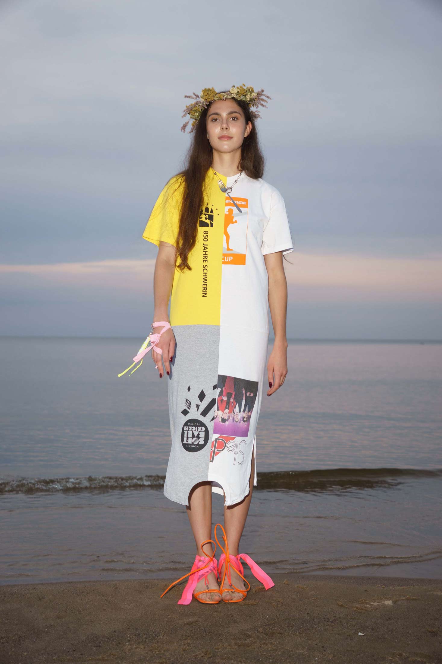 Upcycled loose-fit dress made from four reclaimed vintage cotton t-shirts in  patchwork construction, shown on a model, front view.