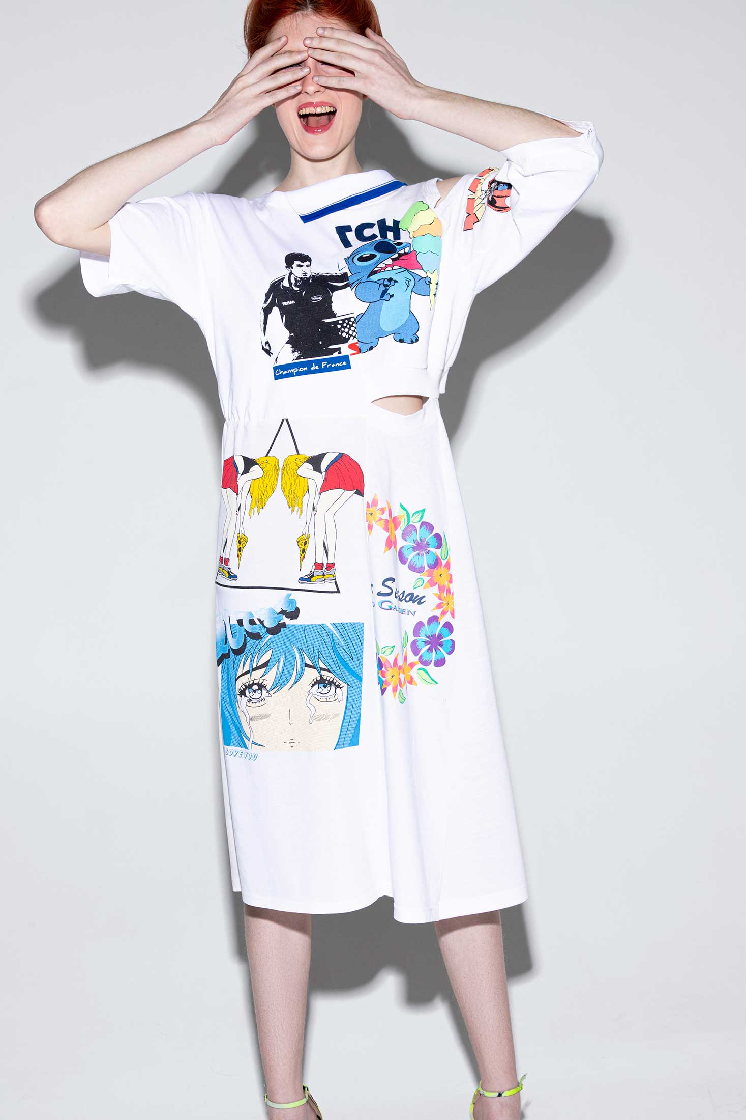 Regenerated graphic knee length dress made from white vintage cotton t-shirts, shown on a model, front view.